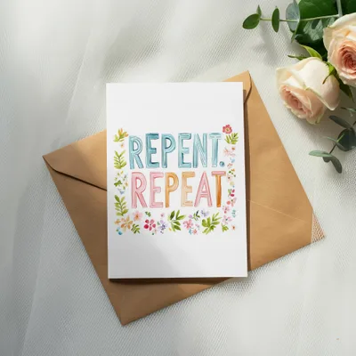 Greeting card with "Repent Repeat" in colorful floral lettering on a kraft envelope.