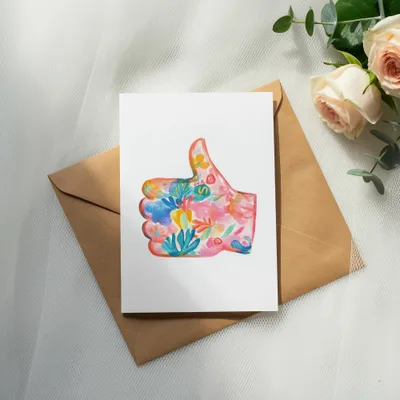 Card with floral thumb up design on brown envelope with roses.