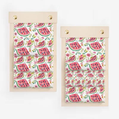 Fabric swatch samples featuring a repeating pattern of sliced watermelons and pink flowers.