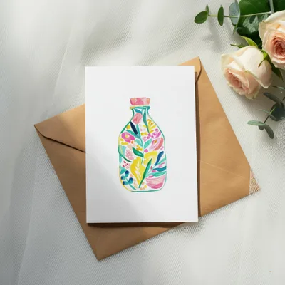 Watercolor illustration of a colorful floral arrangement in a clear bottle.