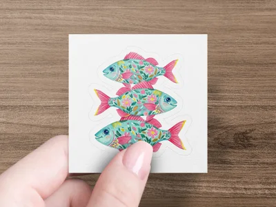Three stylized teal and pink fish stacked vertically with floral patterns.