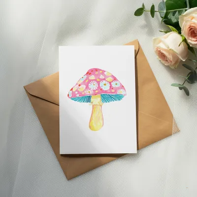 Greeting card with a watercolor mushroom illustration and pink roses.