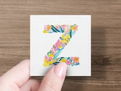 Letter Z decorated with colorful watercolor flowers and leaves.