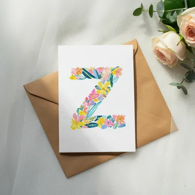 White card with colorful floral letter Z on brown envelope.